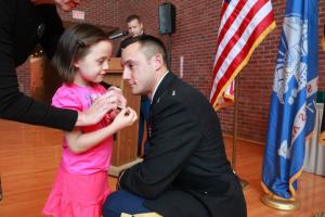 LT Garza receives his bar from his daughter